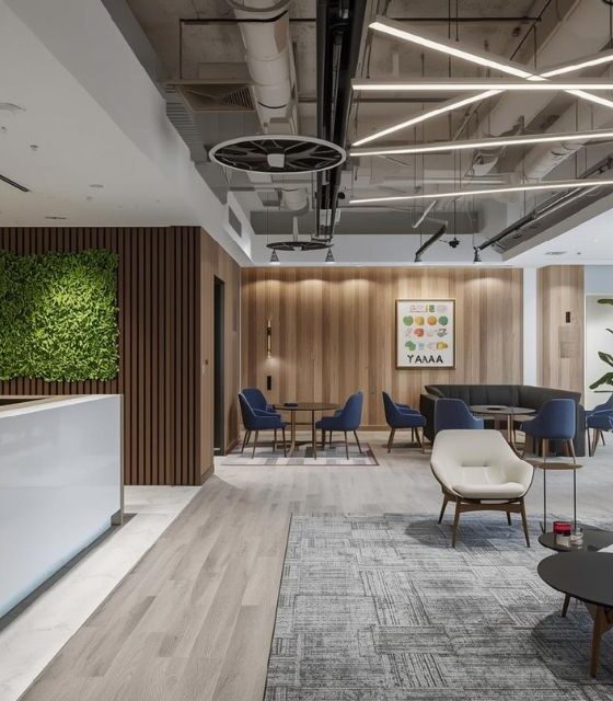 Modern office reception interior with wooden wall panels, green wall, and luxury lighting.